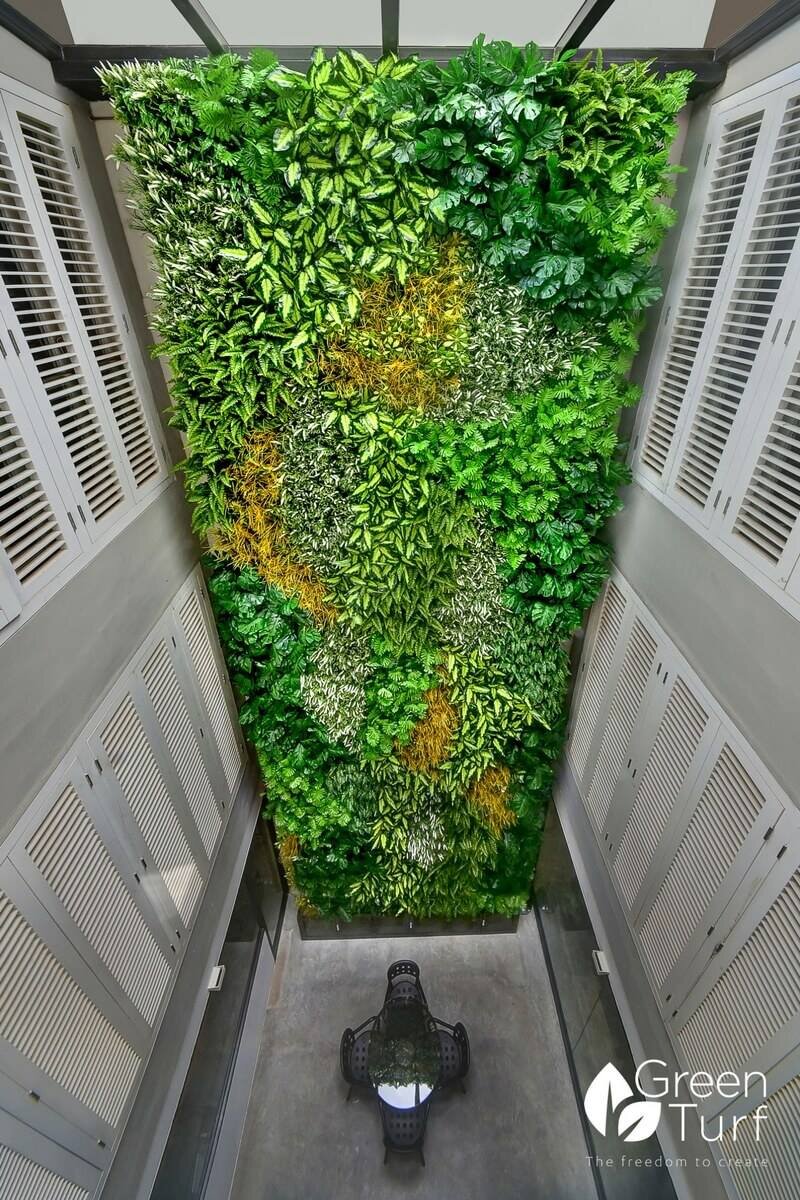 Incorporating a vertical living wall in an air well courtesy Greenturf Asia